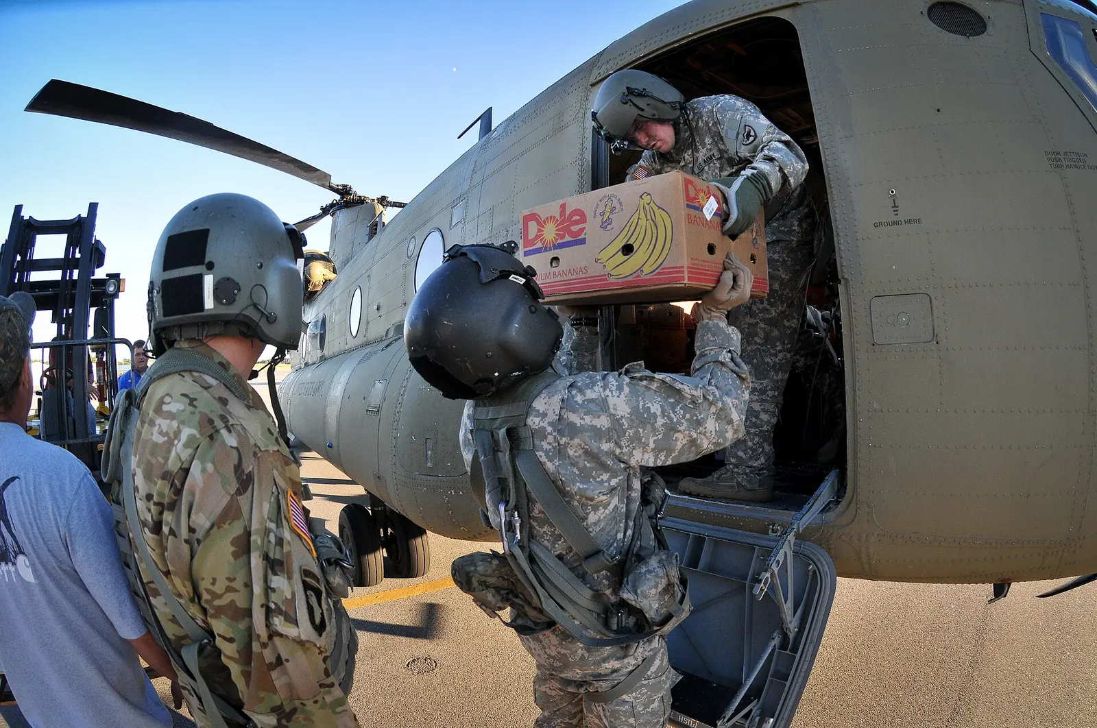 South Carolina National Guard soldiers unload food from a CH-47F Chinook helicopter bound for Beaufort County communities after Hurricane Matthew.