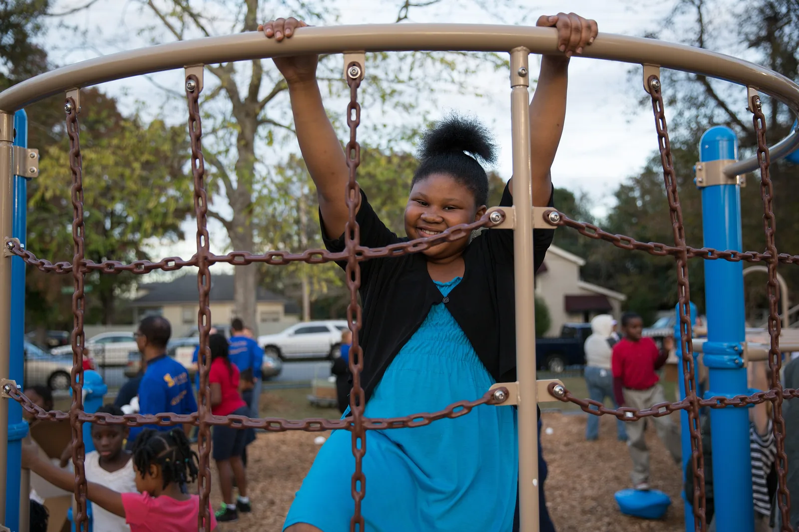 A girl climbs on the rope frame of a new community playground in the Chicora-Cherokee neighborhood of North Charleston, S.C.