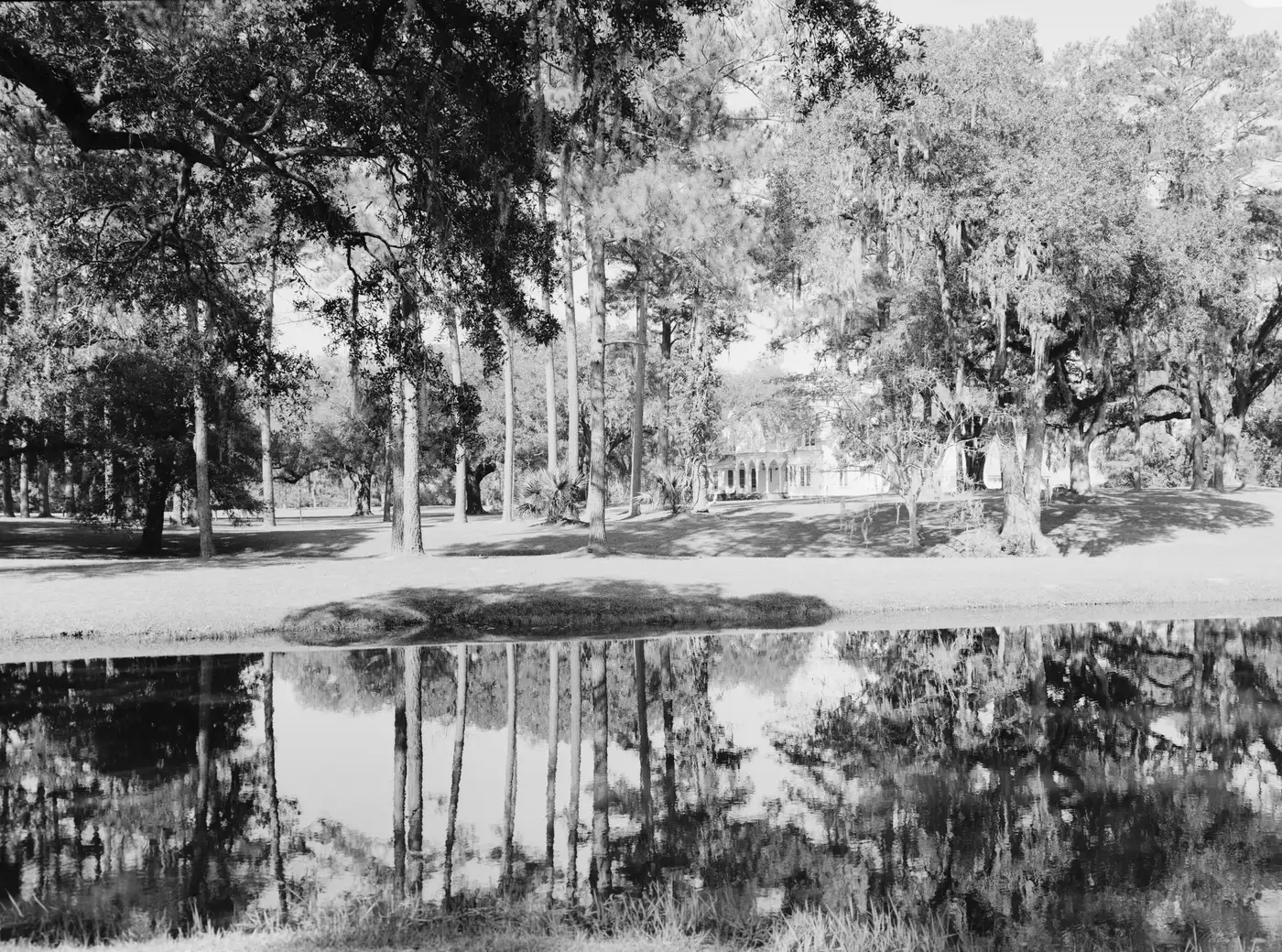 Rose Hill Plantation House seen across a pond, in a Historic American Buildings Survey photograph.