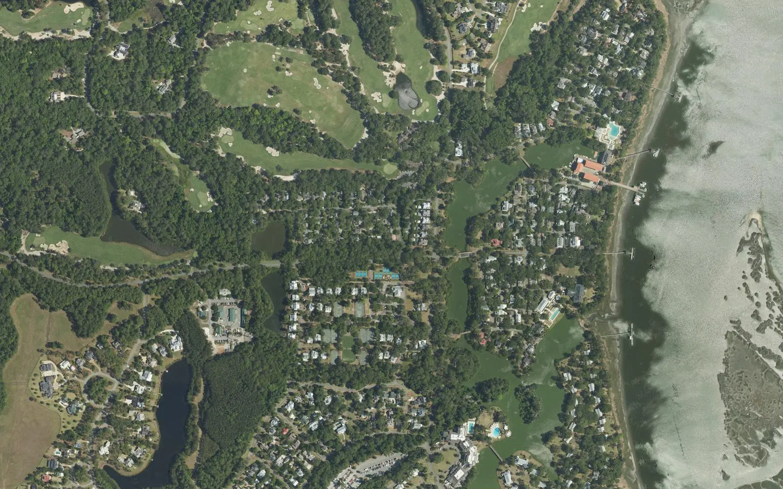 Aerial view of homes, a golf course and docks along the May River in Palmetto Bluff.