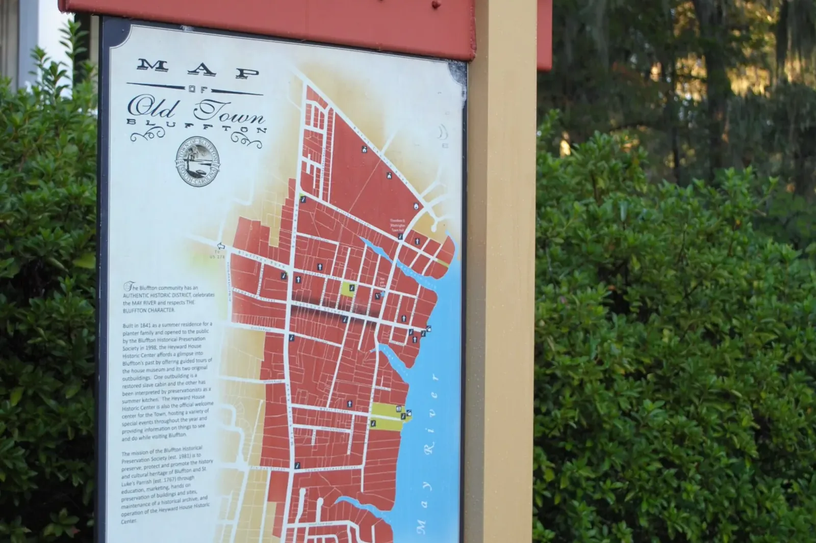A map kiosk for the Old Town Bluffton historic district stands beside a porch in Old Town.