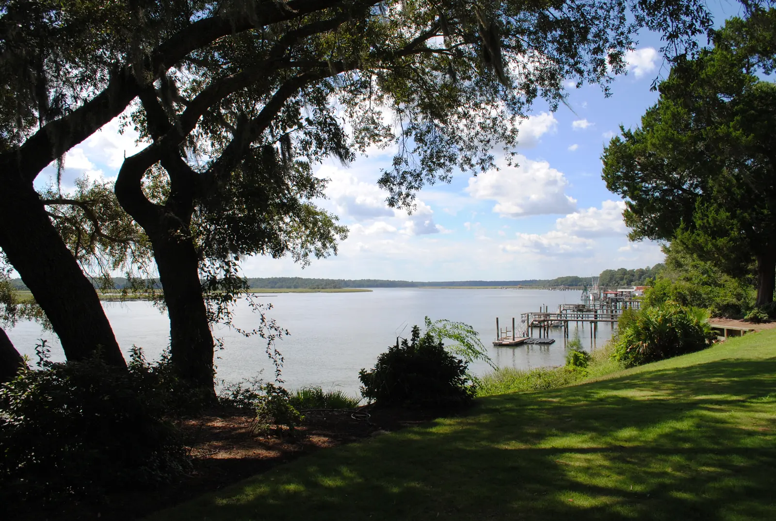 Live oaks frame a view of the May River and private docks from the bluff in Bluffton.